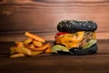 Fresh tasty burger and french fries on wooden table Royalty Free Stock Photo