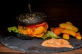 Fresh tasty burger and french fries on wooden table Royalty Free Stock Photo