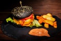 Fresh tasty burger and french fries on wooden table Royalty Free Stock Photo