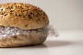 Fresh tasty burger with plastic waste and paper cardboard inside on white background. Recycled waste in our food concept Royalty Free Stock Photo
