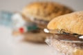 Fresh tasty burger with plastic waste and paper cardboard inside on white background. Recycled waste in our food concept Royalty Free Stock Photo