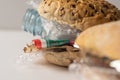 Fresh tasty burger with plastic waste and paper cardboard inside on white background. Recycled waste in our food concept Royalty Free Stock Photo