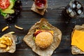 Fresh tasty burgers with french fries, sauce and drink on the wooden table top view Royalty Free Stock Photo