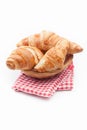 Fresh and tasty croissant on red checkered napkin