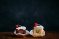 Fresh tasty cupcakes with berries. Selective focus. Dark wooden background.Rustic style, place for text. cut cupcakes Royalty Free Stock Photo