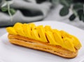 Fresh tasty eclair on white plate closeup Royalty Free Stock Photo