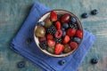 Fresh tasty fruit salad on blue wooden table Royalty Free Stock Photo