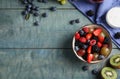 Fresh tasty fruit salad on blue wooden table. Space for text Royalty Free Stock Photo