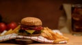 Fresh tasty grilled burger and french fries serving with beverage in restaurant Royalty Free Stock Photo