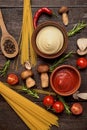 Fresh tasty ingredients for healthy cooking with red and mushroom sauce and pasta Royalty Free Stock Photo