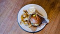 A fresh, tasty, juicy hamburger with cheese, tomatoes, seasoned marbled beef, fresh lettuce, mayonnaise sauce and Royalty Free Stock Photo