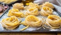 Fresh linguine pasta twirled on sheet pan