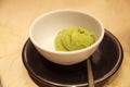 Fresh tasty matcha green tea flavored ice cream served in white bowl on table background. Healthy sweets, summer desserts, Royalty Free Stock Photo