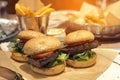 Fresh tasty meat burger and french fries on wooden table Royalty Free Stock Photo