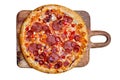 Fresh tasty pizza with pepperoni, salami, onion, tomatoes and cheese on wooden cutting board isolated on white background. Top Royalty Free Stock Photo