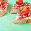 Fresh tasty salami sandwiches. Appetizing sandwiches with smoked Royalty Free Stock Photo