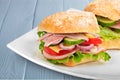 Fresh tasty sandwich with ham on plate, close-up Royalty Free Stock Photo