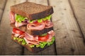 Fresh tasty sandwich on wooden background Royalty Free Stock Photo