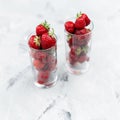 Fresh tasty strawberries in a glass on a white table. Strawberry cocktail concept Royalty Free Stock Photo