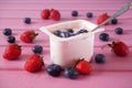 Fresh tasty yogurt and strawberries and blueberries on wooden background. Healthy Breakfast Concept Royalty Free Stock Photo