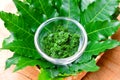 Fresh Thai herb mashed neem leaf on glass bowl.