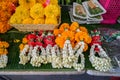 Fresh Thai style flower garlands made of white jasmine, crown flower, red rose and yellow marigold with betel nut tray Royalty Free Stock Photo