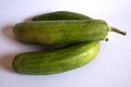 Fresh three green cucumbers with white background