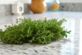 fresh thyme sprigs on a marble countertop