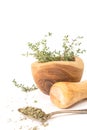 Fresh thyme in wooden mortar with pestle, on withe background. Royalty Free Stock Photo