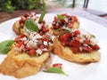 Fresh Tomato Bruschetta on the white plate.