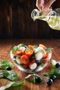Fresh tomato, cheese and spinach salad on wooden background. Healthy diet.