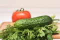 Fresh tomato, cucumber, parsley and dill on the cutting board Royalty Free Stock Photo