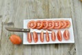 Fresh Tomato cut slices in plate on wooden background Royalty Free Stock Photo