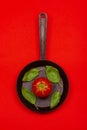 Fresh tomato on frying pan with basilic. Royalty Free Stock Photo