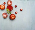 Fresh tomato juice in a glass with a straw, with green leaf, chopped tomatoes spread around border ,text area wooden rusti