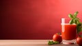 Fresh tomato juice in glass on wooden table with solid red background for text placement