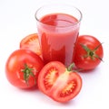 Fresh tomato juice and ripe tomatoes round glass.