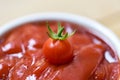 Fresh tomato on ketchup background Close up tomato sauce in cup - selective focus Royalty Free Stock Photo