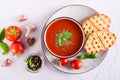 Fresh tomato soup with basil in a bowl and fresh vegetables on the table. Top view Royalty Free Stock Photo