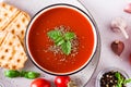 Fresh tomato soup with basil in a bowl and fresh vegetables on the table. Top view. Closeup Royalty Free Stock Photo