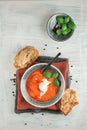 Fresh Tomato soup in a bowl with tomatoes and basil on a white kitchen table Royalty Free Stock Photo