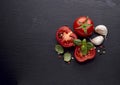 Fresh  tomatoes, basil, garlic on black  stone background Royalty Free Stock Photo