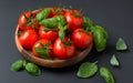 Fresh tomatoes in a basket with mint.Wooden table Royalty Free Stock Photo