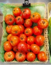 Fresh tomatoes on a basket. Ripe tomatoes sell on a local market.