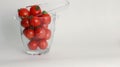 Fresh red tomatoes cherry in a glass bowl isolated on white Royalty Free Stock Photo