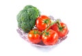 Fresh tomatoes and broccoli in basket isolated on white background Royalty Free Stock Photo