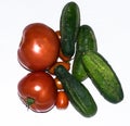 Fresh tomatoes and cucumbers on a white background. Royalty Free Stock Photo