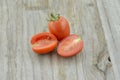 Fresh Tomatoes cut half on wooden background, decorate Royalty Free Stock Photo