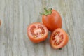 Fresh Tomatoes cut half on wooden background, decorate Royalty Free Stock Photo