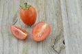 Fresh Tomatoes cut half on wooden background, decorate Royalty Free Stock Photo